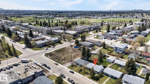 Aerial perspective showcasing a residential street with mature trees and a distant urban skyline - 13412 108 Street, Edmonton, AB - Outdoor With View