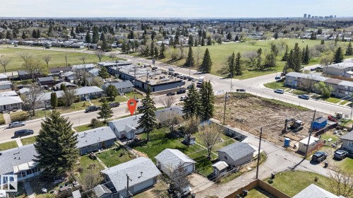 Aerial overview featuring a residential street with mature trees, green spaces, and surrounding commercial structures - 13412 108 Street, Edmonton, AB - Outdoor With View