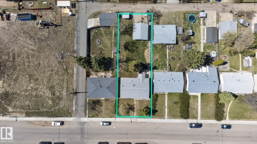 Aerial view of the property outlined in teal, featuring a single-story residence with a gray roof and a detached structure toward the rear - 13412 108 Street, Edmonton, AB - 