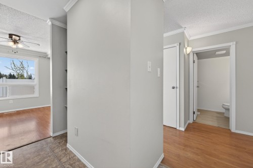Hallway featuring wood-finish flooring, light grey walls, and white trim - 18 17409 95 Street, Edmonton, AB - Indoor Photo Showing Other Room