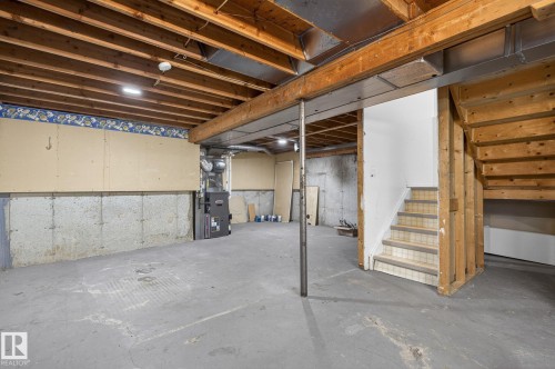 Unfinished basement with concrete flooring and visible wood ceiling joists - 18 17409 95 Street, Edmonton, AB - Indoor Photo Showing Basement