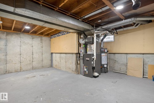 Unfinished basement with concrete walls and flooring, exposed wood ceiling joists, and integrated HVAC systems - 18 17409 95 Street, Edmonton, AB - Indoor Photo Showing Basement