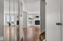 Open-concept interior featuring wood-finish flooring, white walls, and crown molding - 18 17409 95 Street, Edmonton, AB  - Indoor Photo Showing Other Room 