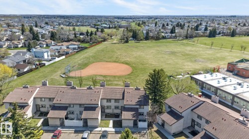 Townhome residences featuring multi-story facades, individual entrances, and private patios - 18 17409 95 Street, Edmonton, AB - Outdoor With View