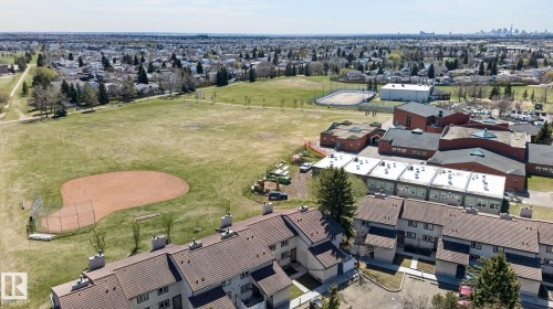 Townhome-style residences with pitched roofs and multiple chimneys - 18 17409 95 Street, Edmonton, AB - Outdoor With View