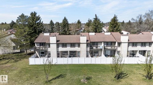 Townhome row with light-toned stucco exteriors and brown roofs - 18 17409 95 Street, Edmonton, AB - Outdoor