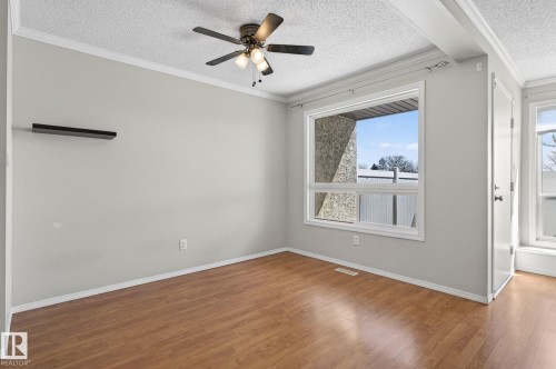 Interior space featuring wood-finish flooring, light gray walls, and white trim - 18 17409 95 Street, Edmonton, AB - Indoor Photo Showing Other Room