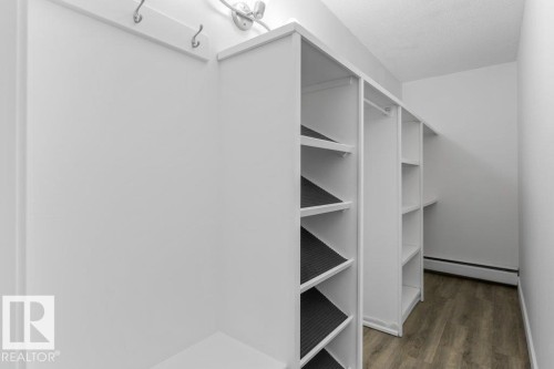 Built-in white shelving units - 101 8604 Gateway Boulevard, Edmonton, AB - Indoor With Storage
