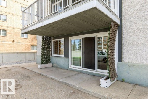 Ground-level patio with sliding glass door access - 101 8604 Gateway Boulevard, Edmonton, AB - Outdoor With Exterior