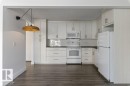 Updated Kitchen and dining area featuring amble  cabinetry, subway tile backsplash & full size appliances, including a dishwasher, fridge, stove & microwave hood fan. - 101 8604 Gateway Boulevard, Edmonton, AB  - Indoor Photo Showing Kitchen 