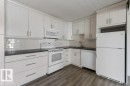 Updated Kitchen and dining area featuring amble  cabinetry, subway tile backsplash & full size appliances, including a dishwasher, fridge, stove & microwave hood fan. - 101 8604 Gateway Boulevard, Edmonton, AB  - Indoor Photo Showing Kitchen 