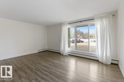 Open-concept living space; Carpet-Free Condo; West Facing Patio Door; - 101 8604 Gateway Boulevard, Edmonton, AB - Indoor Photo Showing Other Room