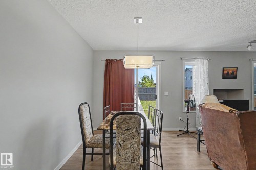 Dining area featuring wood-finish flooring and light gray walls - 1211 29 Street, Edmonton, AB - Indoor Photo Showing Dining Room