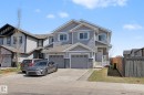 Modern two-story duplex featuring gray siding and stone accents - 1211 29 Street, Edmonton, AB  - Outdoor With Facade 