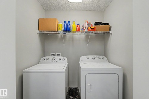 Dedicated laundry area featuring a top-loading washing machine and a front-loading dryer - 1211 29 Street, Edmonton, AB - Indoor Photo Showing Laundry Room