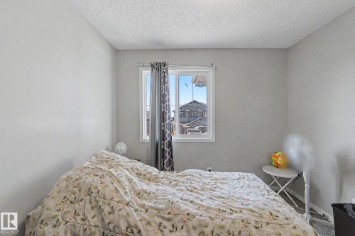 Bedroom with light gray walls, white trim, and a textured ceiling - 1211 29 Street, Edmonton, AB - Indoor Photo Showing Bedroom