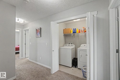 Dedicated laundry closet featuring a built-in wire shelf, washer, and dryer - 1211 29 Street, Edmonton, AB - Indoor Photo Showing Laundry Room