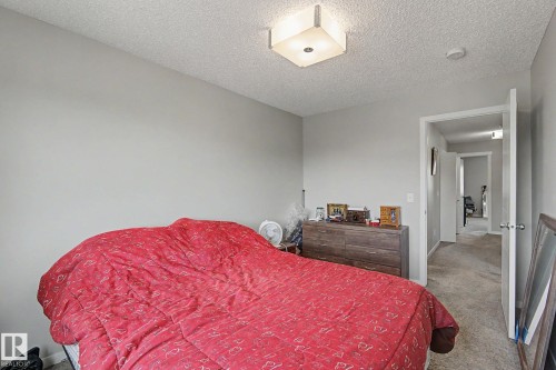 Carpeted room featuring a neutral color palette, recessed lighting, and a doorway opening to a hall - 1211 29 Street, Edmonton, AB - Indoor Photo Showing Bedroom