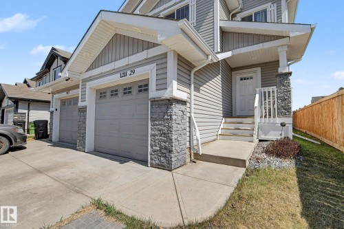 Contemporary exterior featuring horizontal siding and stone accents - 1211 29 Street, Edmonton, AB - Outdoor