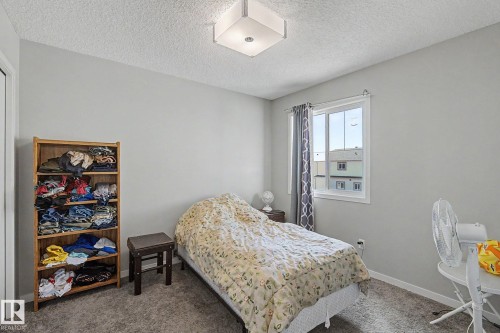 Neutral gray wall paint, textured ceiling, and gray carpet - 1211 29 Street, Edmonton, AB - Indoor Photo Showing Bedroom