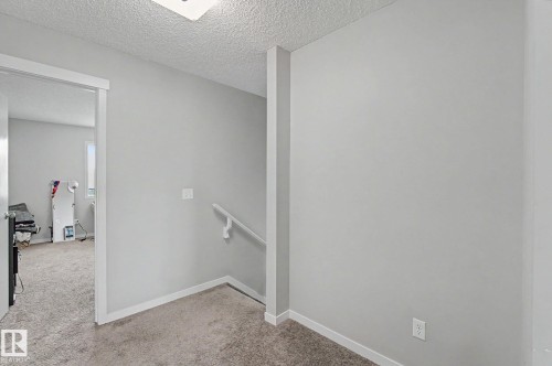 Carpeted hallway featuring light gray walls and white trim - 1211 29 Street, Edmonton, AB - Indoor Photo Showing Other Room