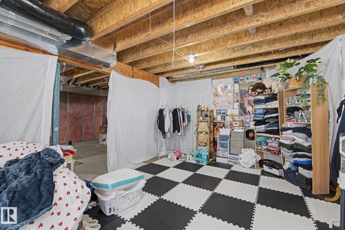 Unfinished basement space featuring exposed wood joists and an open ceiling - 1211 29 Street, Edmonton, AB - Indoor Photo Showing Basement