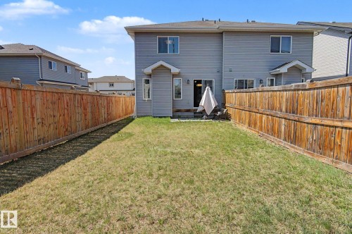 Enclosed backyard featuring privacy fencing, a ground-level patio, and sliding glass door access - 1211 29 Street, Edmonton, AB - Outdoor With Exterior