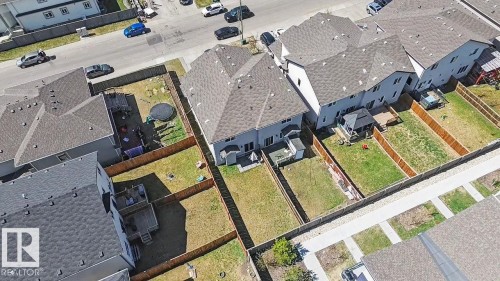 Aerial overview showcasing multiple properties with fenced backyards - 1211 29 Street, Edmonton, AB - 