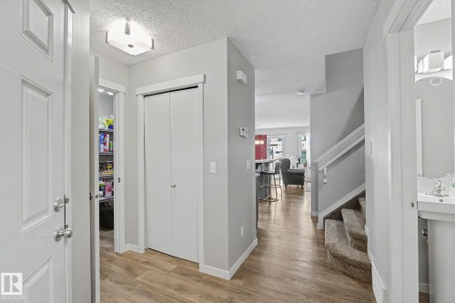 Entryway featuring wood-finish flooring, a flush-mount ceiling light, and a white paneled door - 1211 29 Street, Edmonton, AB - Indoor Photo Showing Other Room