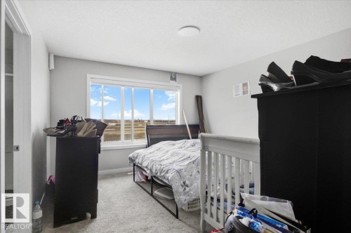 Room featuring light gray walls, white trim, and light-colored carpeting - 7056 182 Avenue, Edmonton, AB - Indoor Photo Showing Bedroom