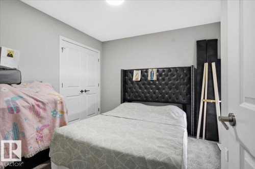 Bedroom featuring light gray wall paint, white trim, and gray carpet flooring - 7056 182 Avenue, Edmonton, AB - Indoor Photo Showing Bedroom