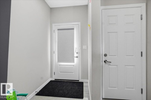 Entryway featuring light gray wall paint, white trim, and two white panel doors - 7056 182 Avenue, Edmonton, AB - Indoor Photo Showing Other Room