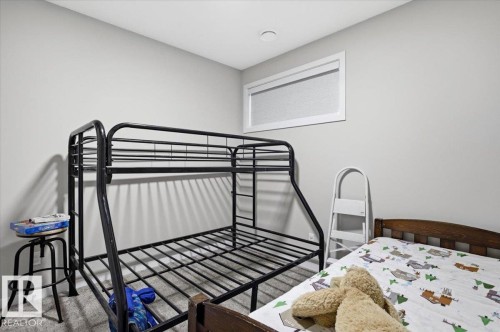Bedroom featuring light gray wall paint and textured gray carpeting - 7056 182 Avenue, Edmonton, AB - Indoor Photo Showing Bedroom