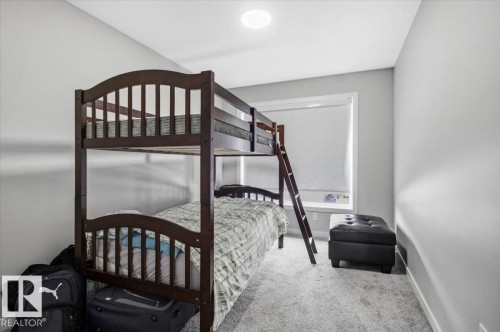 Room featuring light gray painted walls and gray carpet flooring - 7056 182 Avenue, Edmonton, AB - Indoor Photo Showing Bedroom