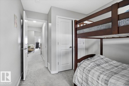 Interior room featuring light gray wall paint and matching gray carpet flooring - 7056 182 Avenue, Edmonton, AB - Indoor Photo Showing Bedroom