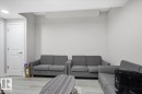 Recessed lighting illuminating a spacious room with light gray walls and wood-finish flooring - 7056 182 Avenue, Edmonton, AB  - Indoor Photo Showing Living Room 