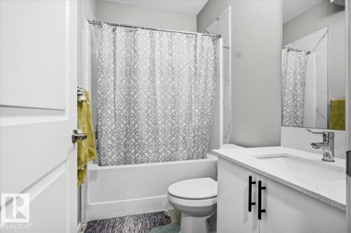 Bathroom with white vanity, integrated sink, and chrome faucet - 7056 182 Avenue, Edmonton, AB - Indoor Photo Showing Bathroom