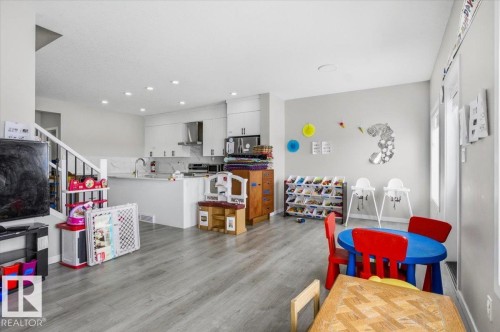 Open-concept living space featuring wood-finish flooring and recessed lighting - 7056 182 Avenue, Edmonton, AB - Indoor
