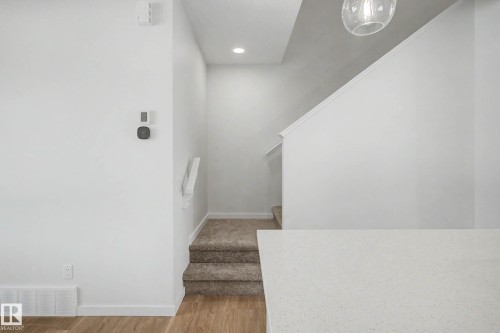 Carpeted staircase with white handrail and recessed lighting - 720 Southfork Drive, Leduc, AB - Indoor Photo Showing Other Room
