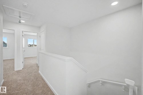 Upper-level hallway featuring neutral carpeting, recessed lighting, and white painted walls - 720 Southfork Drive, Leduc, AB - Indoor Photo Showing Other Room
