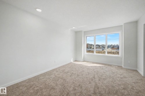 Spacious room featuring neutral carpeting, white walls, and recessed lighting - 720 Southfork Drive, Leduc, AB - Indoor Photo Showing Other Room