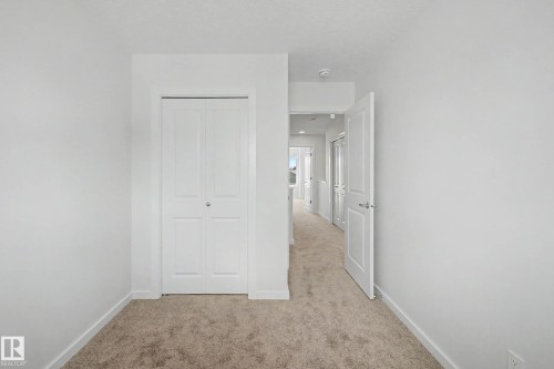 Interior space featuring plush carpet flooring and white painted walls - 720 Southfork Drive, Leduc, AB - Indoor