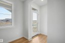 Bright interior space with wood-finish flooring, white walls, and a white trim package - 720 Southfork Drive, Leduc, AB  - Indoor Photo Showing Other Room 