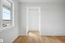Bright interior space featuring wood-finish flooring, white walls, and a large multi-pane window - 720 Southfork Drive, Leduc, AB  - Indoor Photo Showing Other Room 