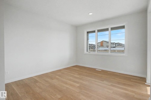 Room featuring wood-finish flooring, recessed lighting, white trim, and a multi-pane window - 720 Southfork Drive, Leduc, AB - Indoor Photo Showing Other Room