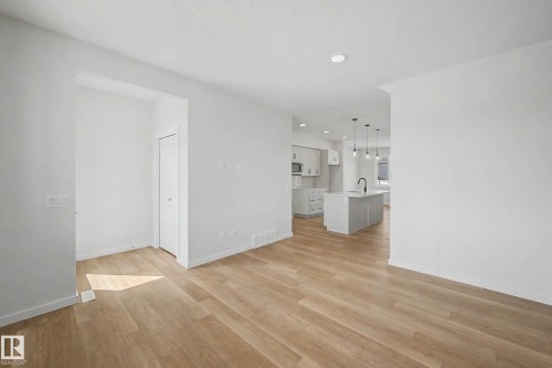 Open-concept living space featuring wood-finish flooring, recessed lighting, and white baseboards - 720 Southfork Drive, Leduc, AB - Indoor Photo Showing Other Room