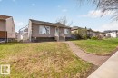 Single-story residence featuring a stucco exterior with decorative quoins, multiple windows, and a raised entry with steps and railings - 9723 65 Avenue, Edmonton, AB  - Outdoor 