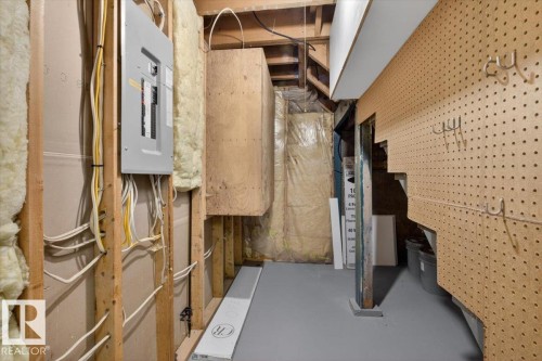 Utility area featuring a circuit breaker panel, exposed wood framing, and insulation - 9723 65 Avenue, Edmonton, AB - Indoor Photo Showing Basement
