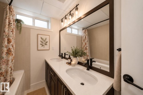 Dual vanity with undermount sinks, white countertop, and dark wood-finish cabinetry - 126 Harrison Drive, Edmonton, AB - Indoor Photo Showing Bathroom