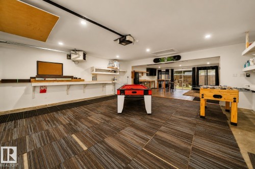 Versatile flex space featuring striped plank flooring and recessed lighting - 126 Harrison Drive, Edmonton, AB - Indoor Photo Showing Other Room